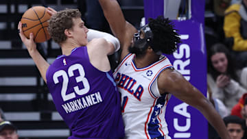 Dec 28, 2024; Salt Lake City, Utah, USA; Utah Jazz forward Lauri Markkanen (23) goes to the basket against Philadelphia 76ers center Joel Embiid (21) during the second quarter at Delta Center. Mandatory Credit: Rob Gray-Imagn Images