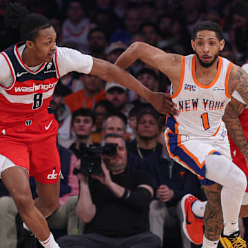 Mar 22, 2025; New York, New York, USA; New York Knicks guard Cameron Payne (1) dribbles up court in front of Washington Wizards guard Bub Carrington (8) and forward Justin Champagnie (9) during the first quarter at Madison Square Garden. Mandatory Credit: Vincent Carchietta-Imagn Images