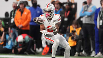 Ohio State Buckeyes wide receiver Emeka Egbuka (2) catches a pass against the Notre Dame Fighting Irish in the first half in the CFP National Championship college football game at Mercedes-Benz Stadium.