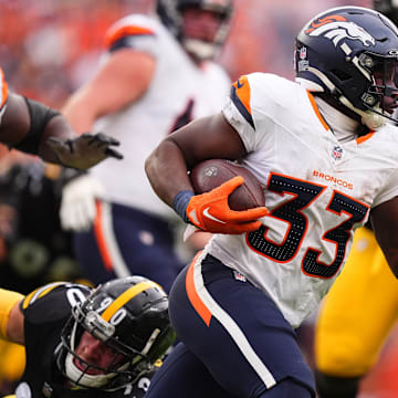 Sep 15, 2024; Denver, Colorado, USA; Denver Broncos running back Javonte Williams (33) carries the ball in the second half against the Pittsburgh Steelers at Empower Field at Mile High. 