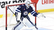 Apr 21, 2024; Winnipeg, Manitoba, CAN; Winnipeg Jets goaltender Connor Hellebuyck (37) warms before a game against the Colorado Avalanche in game one of the first round of the 2024 Stanley Cup Playoffs at Canada Life Centre. Mandatory Credit: James Carey Lauder-USA TODAY Sports