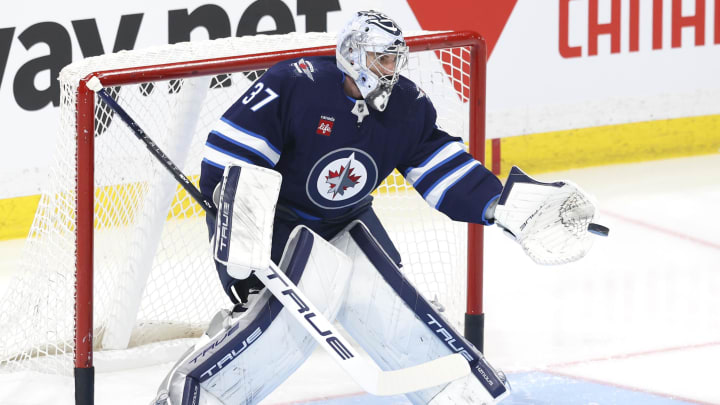 Apr 21, 2024; Winnipeg, Manitoba, CAN; Winnipeg Jets goaltender Connor Hellebuyck (37) warms before a game against the Colorado Avalanche in game one of the first round of the 2024 Stanley Cup Playoffs at Canada Life Centre. Mandatory Credit: James Carey Lauder-USA TODAY Sports