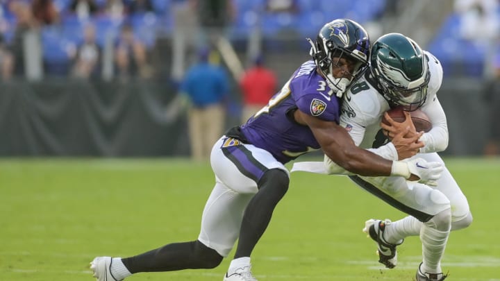 Aug 12, 2023; Baltimore, Maryland, USA;  Philadelphia Eagles quarterback Marcus Mariota (8) rushes for a first down as Baltimore Ravens safety Jaquan Amos (37) tackles during the first half at M&T Bank Stadium. Mandatory Credit: Tommy Gilligan-USA TODAY Sports