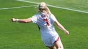 Nebraska midfielder Reagan Raabe plays a ball into the box against Iowa.