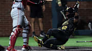 Vanderbilt's RJ Austin (42) scores a run past Alabama's Brady Neal (10) during their game at Vanderbilt’s Hawkins Field Friday, May 2, 2025.