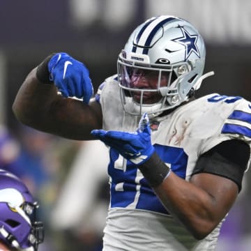 Nov 20, 2022; Minneapolis, Minnesota, USA; Dallas Cowboys defensive end Dorance Armstrong (right) reacts with defensive end DeMarcus Lawrence (left) against the Minnesota Vikings during the third quarter at U.S. Bank Stadium. Mandatory Credit: Jeffrey Becker-USA TODAY Sports