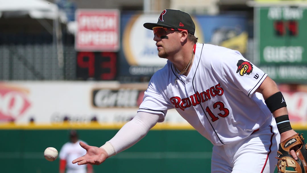 Rochester first baseman Travis Blankenhorn fields and flips the ball to his pitcher covering first to put out Buffalo's Vinny Capra in the third inning.