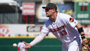 Rochester first baseman Travis Blankenhorn fields and flips the ball to his pitcher covering first to put out Buffalo's Vinny Capra in the third inning.