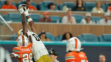 Aug 31, 2025; Miami Gardens, Florida, USA; Notre Dame Fighting Irish wide receiver Malachi Fields (0) makes a catch over Miami Hurricanes defensive back OJ Frederique Jr. (29) during the third quarter at Hard Rock Stadium. Mandatory Credit: Sam Navarro-Imagn Images