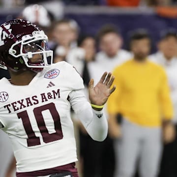 Dec 27, 2023; Houston, TX, USA; Texas A&M Aggies quarterback Marcel Reed (10) drops back to pass against the Oklahoma State Cowboys in the second quarter at NRG Stadium. Mandatory Credit: Thomas Shea-Imagn Images