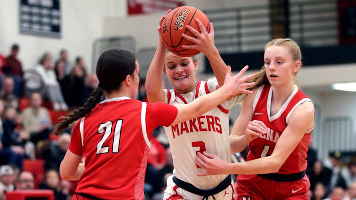 Kimberly High School's Emily Urban (3) drives to the basket against Neenah High School's Ava Kreger (21) and Celia Gentile (4) during their girls basketball game Friday, January 24, 2025, in Kimberly, Wisconsin. Kimberly won 75-38.