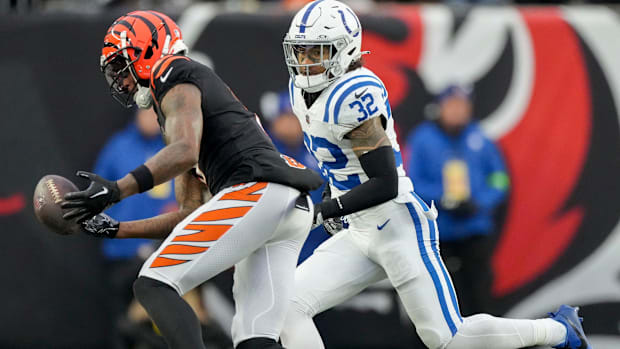 Colts safety Julian Blackmon (all-white uniform; blue trim) gets ready to make a tackle on an opponent receiver. 