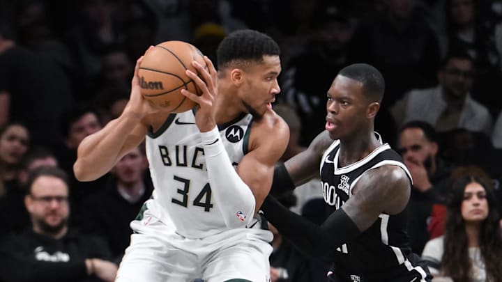 Dec 8, 2024; Brooklyn, New York, USA; Milwaukee Bucks forward Giannis Antetokounmpo (34) posts up against Brooklyn Nets guard Dennis Schroder (17) during the first half at Barclays Center. Mandatory Credit: John Jones-Imagn Images
