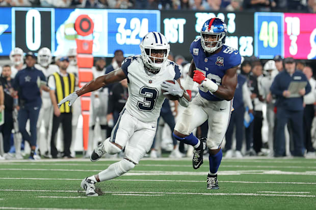 Dallas Cowboys wide receiver Brandin Cooks runs with the ball against New York Giants linebacker Bobby Okereke.