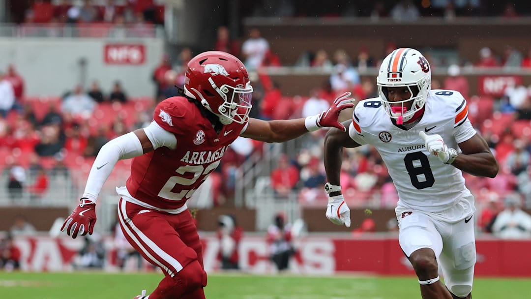 Oct 25, 2025; Fayetteville, Arkansas, USA; Auburn Tigers wide receiver Cam Coleman (8) runs a route resulting in a touchdown catch as Arkansas Razorbacks defensive back Julian Neal (23) defends during the first quarter at Donald W. Reynolds Razorback Stadium. Mandatory Credit: Nelson Chenault-Imagn Images