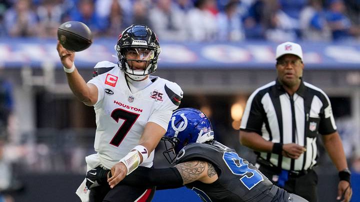 Houston Texans quarterback C.J. Stroud (7) looks to fire off a pass as Indianapolis Colts defensive end Laiatu Latu (97) closes in for the tackle Sunday, Sept. 27, 2026, during a game against the Houston Texans at Lucas Oil Stadium in Indianapolis.