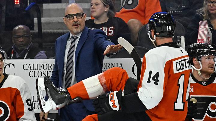 Oct 3, 2026; Philadelphia, Pennsylvania, USA; Philadelphia Flyers head coach Rick Tocchet talks with center Sean Couturier (14) against the Carolina Hurricanes during the second period at Xfinity Mobile Arena.