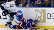 Jan 16, 2024; New York, New York, USA; New York Rangers left wing Alexis Lafreniere (13) and Seattle Kraken defenseman Brian Dumoulin (8) fight for the puck during the third period at Madison Square Garden. Mandatory Credit: Brad Penner-Imagn Images