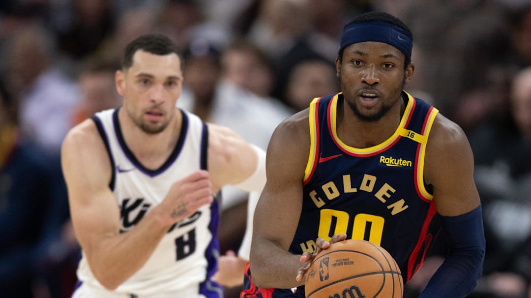 Mar 13, 2025; San Francisco, California, USA; Golden State Warriors forward Jonathan Kuminga (00) brings the ball up court ahead of Sacramento Kings guard Zach LaVine (8) during the fourth quarter at Chase Center. Mandatory Credit: D. Ross Cameron-Imagn Images