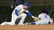 New York Mets pinch-runner Luisangel Acuna (2) steals second as Chicago Cubs second baseman Nico Hoerner (2) can’t handle a throw during the eighth inning at Wrigley Field. 