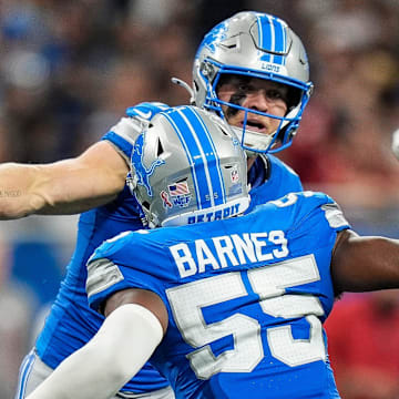 Detroit Lions defensive end Aidan Hutchinson (97) and linebacker Derrick Barnes (55) celebrate