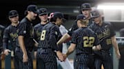 Vanderbilt's JD Thompson (22) is congratulated by teammates after striking out a batter during their game against Alabama at Vanderbilt’s Hawkins Field Friday, May 2, 2025.