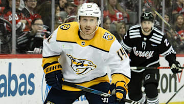 Apr 7, 2024; Newark, New Jersey, USA;  Nashville Predators center Gustav Nyquist (14) skates past New Jersey Devils defenseman Brendan Smith (2)during the third period at Prudential Center. Mandatory Credit: John Jones-Imagn Images