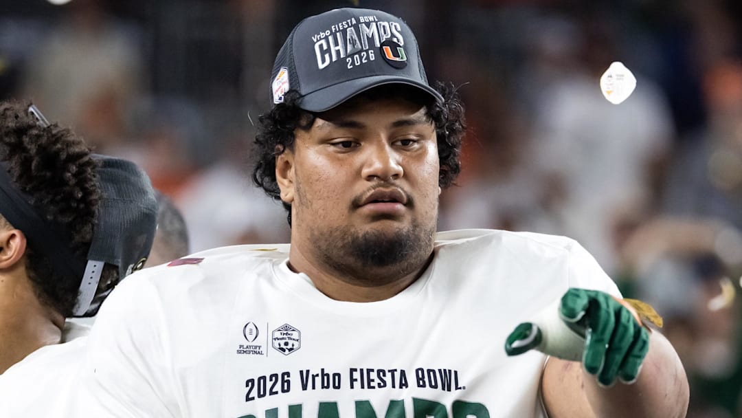 Jan 8, 2026; Glendale, AZ, USA; Miami Hurricanes offensive lineman Francis Mauigoa (61) celebrates after defeating the Mississippi Rebels during the 2026 Fiesta Bowl and semifinal game of the College Football Playoff at State Farm Stadium. Mandatory Credit: Mark J. Rebilas-Imagn Images
