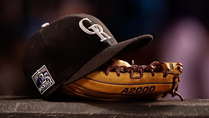 May 10, 2018; Denver, CO, USA; A detail view of a Colorado Rockies players hat and glove in the fifth inning against the Milwaukee Brewers at Coors Field. May 10, 2018; Denver, CO, USA; A detail view of a Colorado Rockies players hat and glove in the fifth inning against the Milwaukee Brewers at Coors Field.