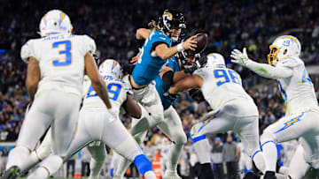Jacksonville Jaguars quarterback Trevor Lawrence (16) scores a two point conversion between Los Angeles Chargers defensive tackle Sebastian Joseph-Day (69) and defensive tackle Breiden Fehoko (96) during the fourth quarter of an NFL first round playoff football matchup Saturday, Jan. 14, 2023 at TIAA Bank Field in Jacksonville, 