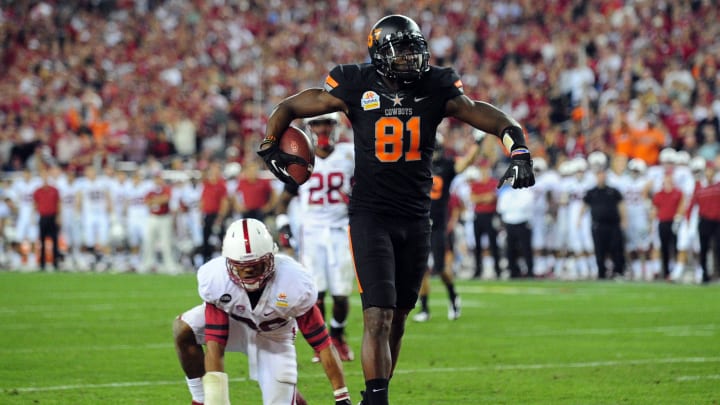 Jan 2, 2012; Glendale, AZ, USA;  Oklahoma State Cowboys wide receiver Justin Blackmon (81) celebrates after scoring a touchdown in the second half against the Stanford Cardinal in the 2012 Fiesta Bowl at University of Phoenix Stadium. The Oklahoma State Cowboys beat the Stanford Cardinal 41-38 in overtime.  Mandatory Credit: Matt Kartozian-USA TODAY Sports