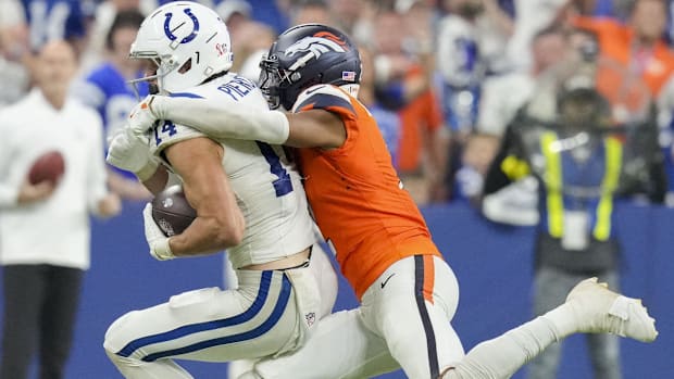 Denver Broncos cornerback Pat Surtain II (2) works to bring down Indianapolis Colts wide receiver Alec Pierce (14).