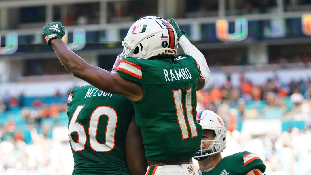 Nov 6, 2021; Miami Gardens, Florida, USA; Miami Hurricanes wide receiver Charleston Rambo (11) celebrates his touchdown against the Georgia Tech Yellow Jackets with offensive lineman Zion Nelson (60) and tight end Will Mallory (85) during the first half at Hard Rock Stadium. Mandatory Credit: Jasen Vinlove-USA TODAY Sports