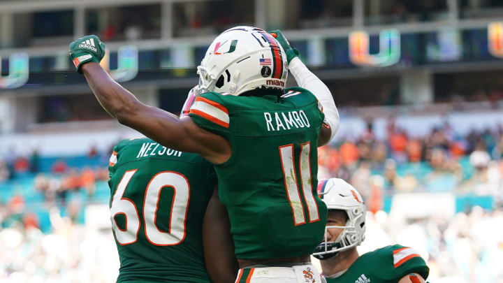 Nov 6, 2021; Miami Gardens, Florida, USA; Miami Hurricanes wide receiver Charleston Rambo (11) celebrates his touchdown against the Georgia Tech Yellow Jackets with offensive lineman Zion Nelson (60) and tight end Will Mallory (85) during the first half at Hard Rock Stadium. Mandatory Credit: Jasen Vinlove-USA TODAY Sports