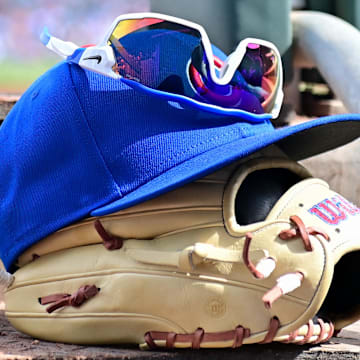 Feb 27, 2024; Mesa, Arizona, USA;  General view of a Chicago Cubs glove, hat and glasses in the first inning against the Cincinnati Reds during a spring training game at Sloan Park. 