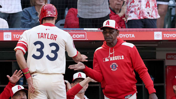 Jun 6, 2025; Anaheim, California, USA; Los Angeles Angels outfielder Chris Taylor (33) celebrates with manager Ron Washington (37) after scoring during the third inning against the Seattle Mariners at Angel Stadium. Mandatory Credit: Jason Parkhurst-Imagn Images Jun 6, 2025; Anaheim, California, USA; Los Angeles Angels outfielder Chris Taylor (33) celebrates with manager Ron Washington (37) after scoring during the third inning against the Seattle Mariners at Angel Stadium. Mandatory Credit: Jason Parkhurst-Imagn Images