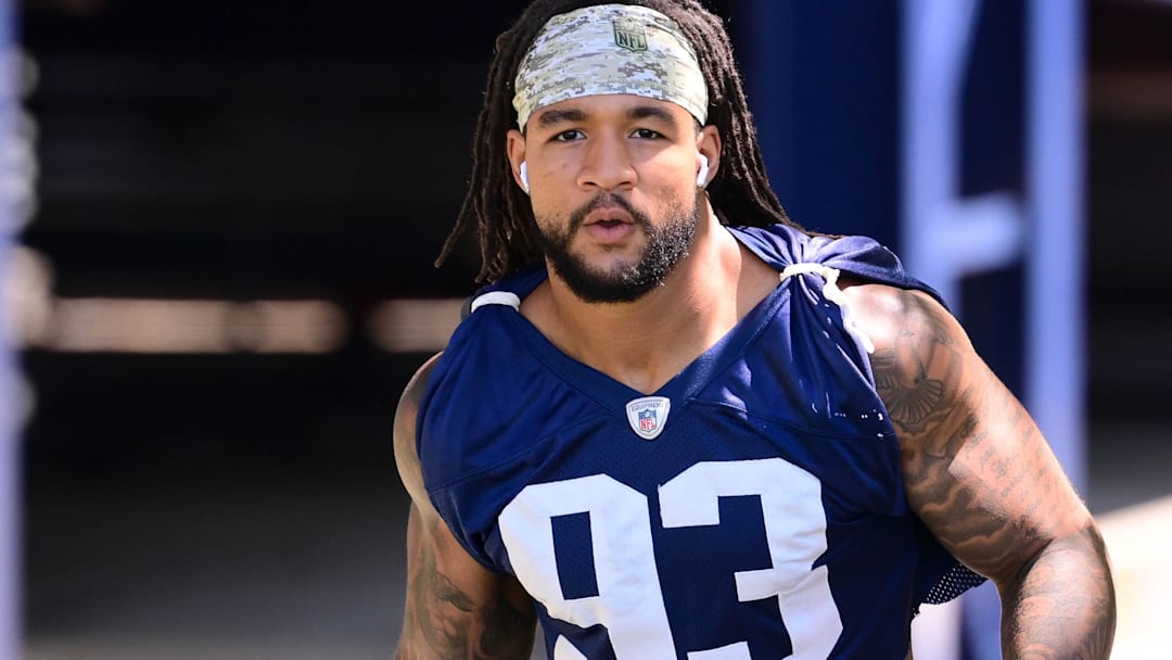 Former New England Patriots linebacker Oshane Ximines (93) walks to the practice fields for minicamp at Gillette Stadium.