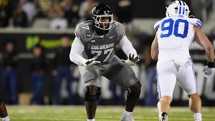 Sep 27, 2025; Boulder, Colorado, USA; Colorado Buffaloes offensive tackle Jordan Seaton (77) pass protects on Brigham Young Cougars defensive end Hunter Clegg (90) in the second quarter at Folsom Field. Mandatory Credit: Ron Chenoy-Imagn Images