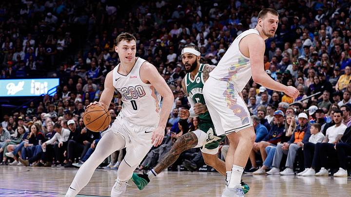 Mar 26, 2025; Denver, Colorado, USA; Denver Nuggets guard Christian Braun (0) controls the ball as center Nikola Jokic (15) screens against Milwaukee Bucks guard Gary Trent Jr. (5) in the second quarter at Ball Arena. Mandatory Credit: Isaiah J. Downing-Imagn Images
