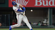 May 13, 2025; Arlington, Texas, USA; Texas Rangers outfielder Wyatt Langford (36) hits a single during the first inning against the Colorado Rockies at Globe Life Field.