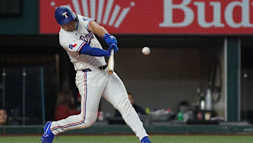 May 13, 2025; Arlington, Texas, USA; Texas Rangers outfielder Wyatt Langford (36) hits a single during the first inning against the Colorado Rockies at Globe Life Field.