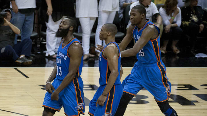 Oklahoma City Thunder guards James Harden (13) and Russell Westbrook (center) and forward Kevin Durant (35) react against the San Antonio Spurs during the second half in game five of the Western Conference finals of the 2012 NBA playoffs at the AT&T Center. Oklahoma City beat San Antonio 108-106. Mandatory Credit: