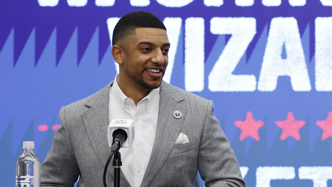 Jan 9, 2026; Washington, District of Columbia, USA; Washington Wizards general manager Will Dawkins (L) introduces newly acquired Wizards guard Trae Young (R) at a press conference prior to the Wizards' game against the New Orleans Pelicans at Capital One Arena. Mandatory Credit: Geoff Burke-Imagn Images