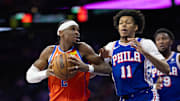 Jan 14, 2025; Philadelphia, Pennsylvania, USA; Oklahoma City Thunder guard Shai Gilgeous-Alexander (2) drives against Philadelphia 76ers guard Jeff Dowtin Jr. (11) during the third quarter at Wells Fargo Center. Mandatory Credit: Bill Streicher-Imagn Images