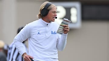 Oct 25, 2025; Bloomington, Indiana, USA; UCLA Bruins interim offensive coordinator Jerry Neuheisel calls a play during the second half against the Indiana Hoosiers at Memorial Stadium. Mandatory Credit: Robert Goddin-Imagn Images
