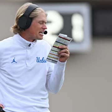 Oct 25, 2025; Bloomington, Indiana, USA; UCLA Bruins interim offensive coordinator Jerry Neuheisel calls a play during the second half against the Indiana Hoosiers at Memorial Stadium. Mandatory Credit: Robert Goddin-Imagn Images