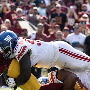 Sep 15, 2024; Landover, Maryland, USA; New York Giants defensive tackle Rakeem Nunez-Roches (93) tackles Washington Commanders quarterback Jayden Daniels (5) in the second half at Commanders Field. Mandatory Credit: Luke Johnson-Imagn Images

