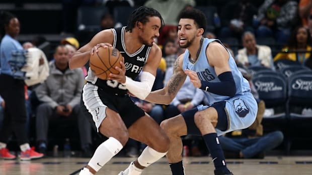 Apr 9, 2024; Memphis, Tennessee, USA; San Antonio Spurs guard Tre Jones (33) handles the ball as Memphis Grizzlies guard Scot