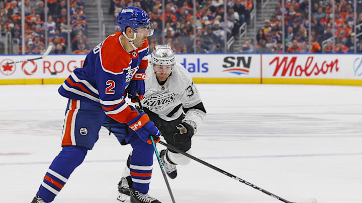 Jan 10, 2026; Edmonton, Alberta, CAN; Edmonton Oilers defensemen Evan Bouchard (2) looks to make a pass in front of Los Angeles Kings forward Warren Foegele (37) during the third period at Rogers Place. Mandatory Credit: Perry Nelson-Imagn Images