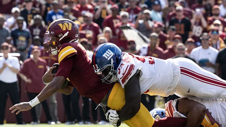 Sep 15, 2024; Landover, Maryland, USA; New York Giants defensive tackle Rakeem Nunez-Roches (93) tackles Washington Commanders quarterback Jayden Daniels (5) in the second half at Commanders Field. Mandatory Credit: Luke Johnson-Imagn Images

